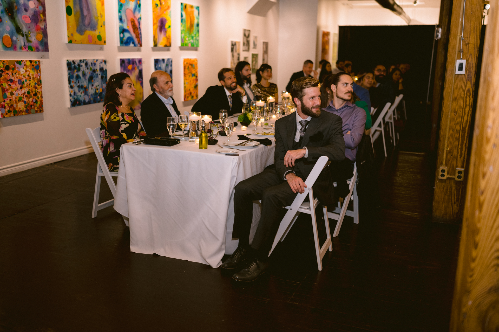 Guests laughing while the couple giving their speech at a wedding.