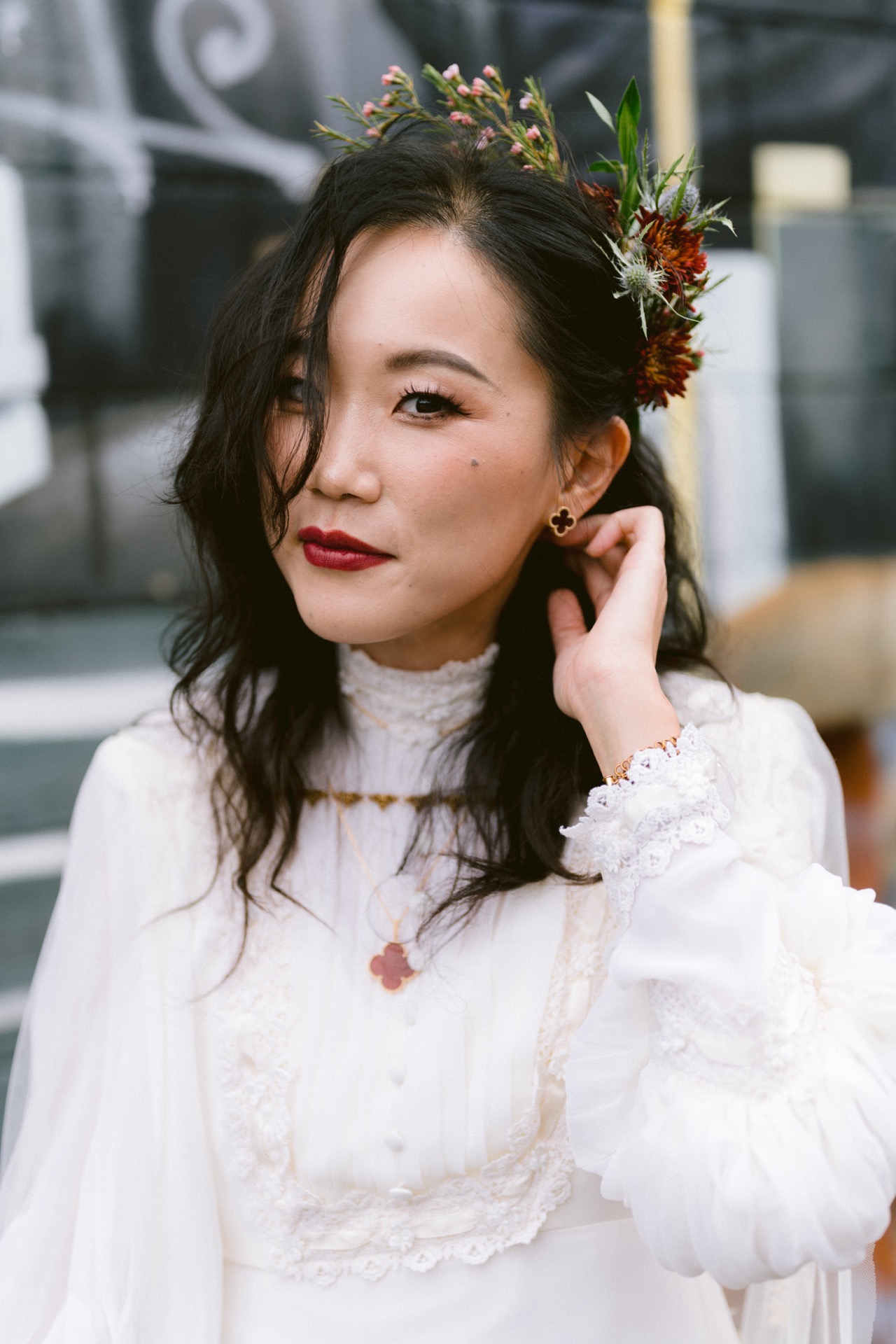 A woman in a white dress adorned with a sunset captures headpiece