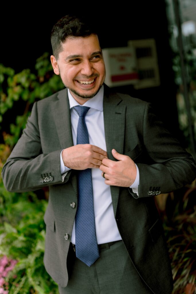 Groom sharing a joke with his groomsmen.
