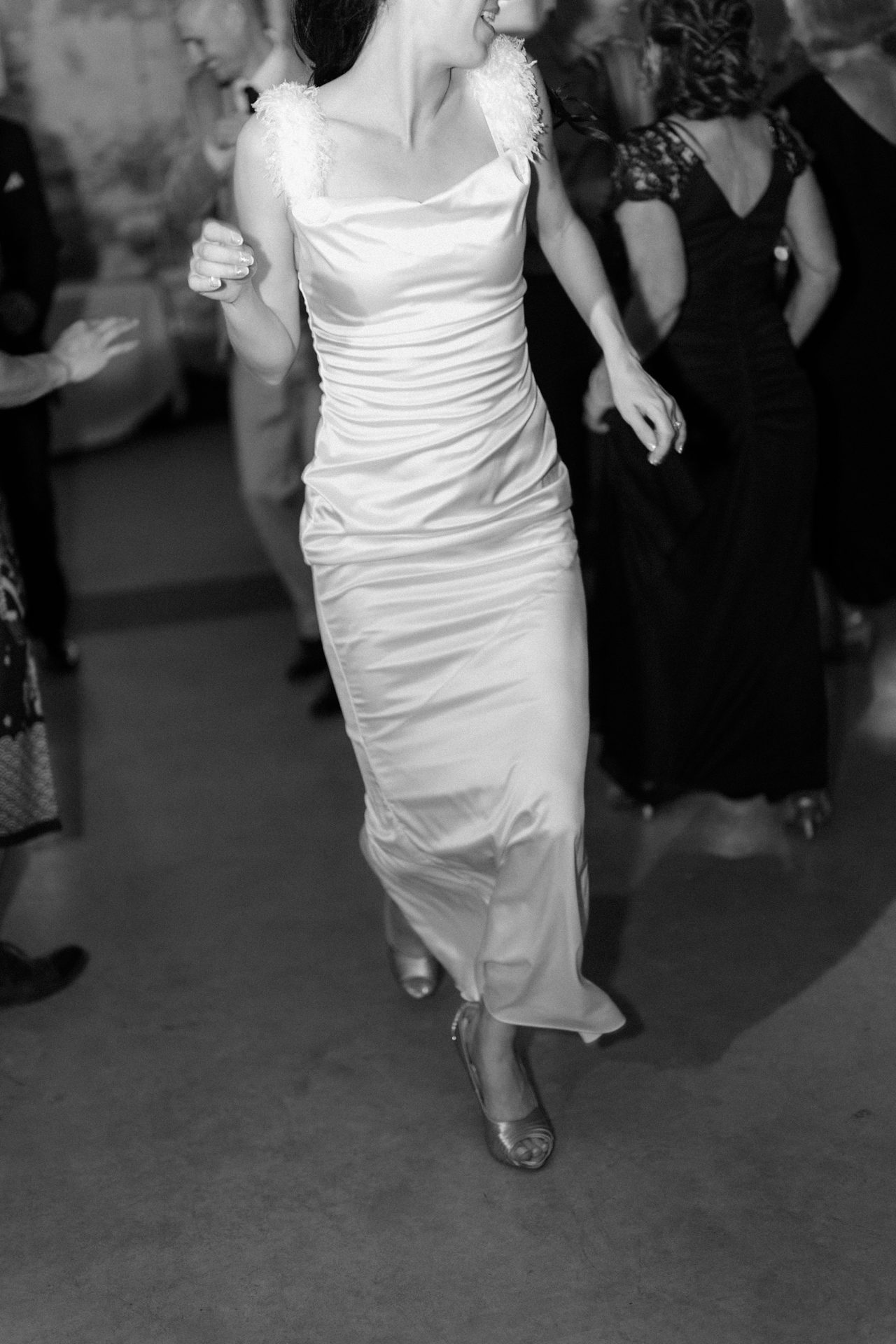 Bride run toward the Toronto wedding photographer on dance floor.