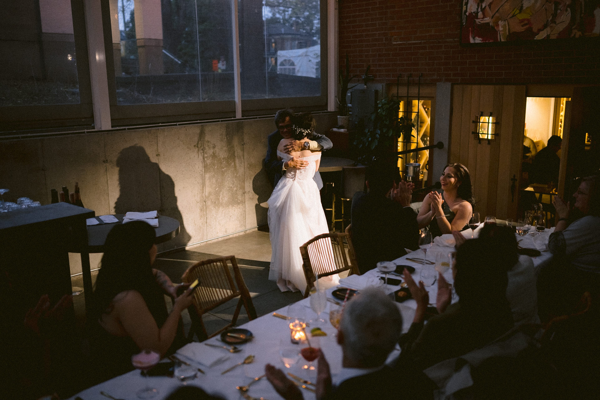 Guests clapping hands after the bride and her father finished the dance.