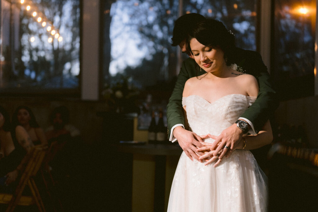 Bride and groom in a tender embrace during their fall wedding reception at Picton Bay