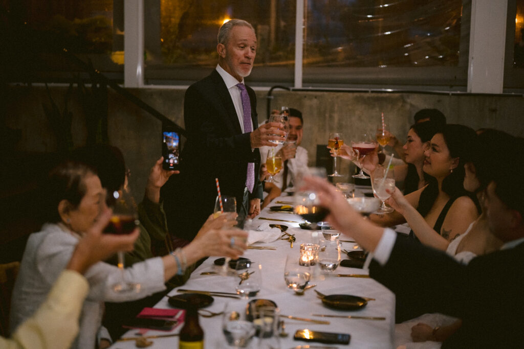 Guests throwing confetti at bride and groom.