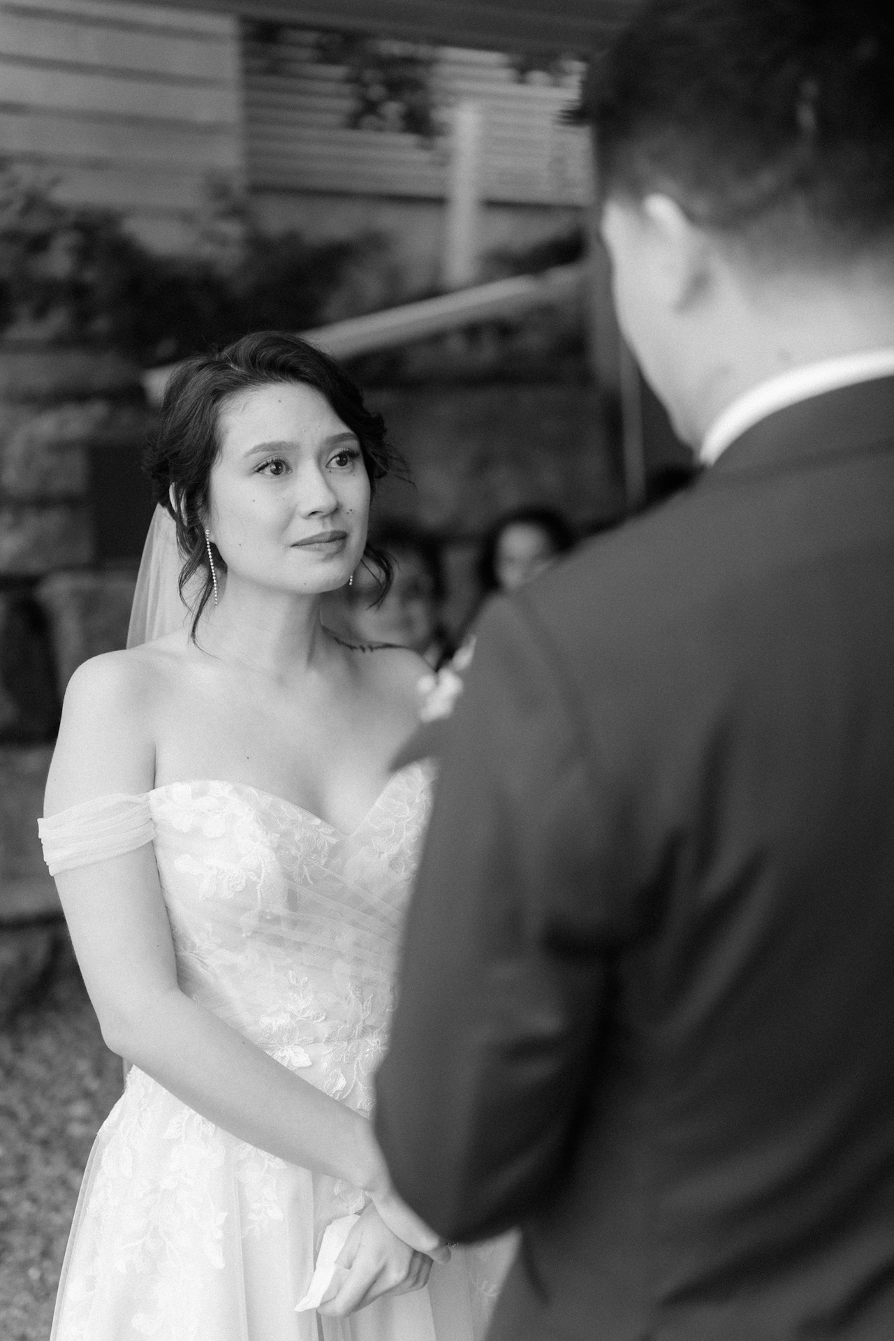 A couple exchanges vows at an outdoor wedding ceremony