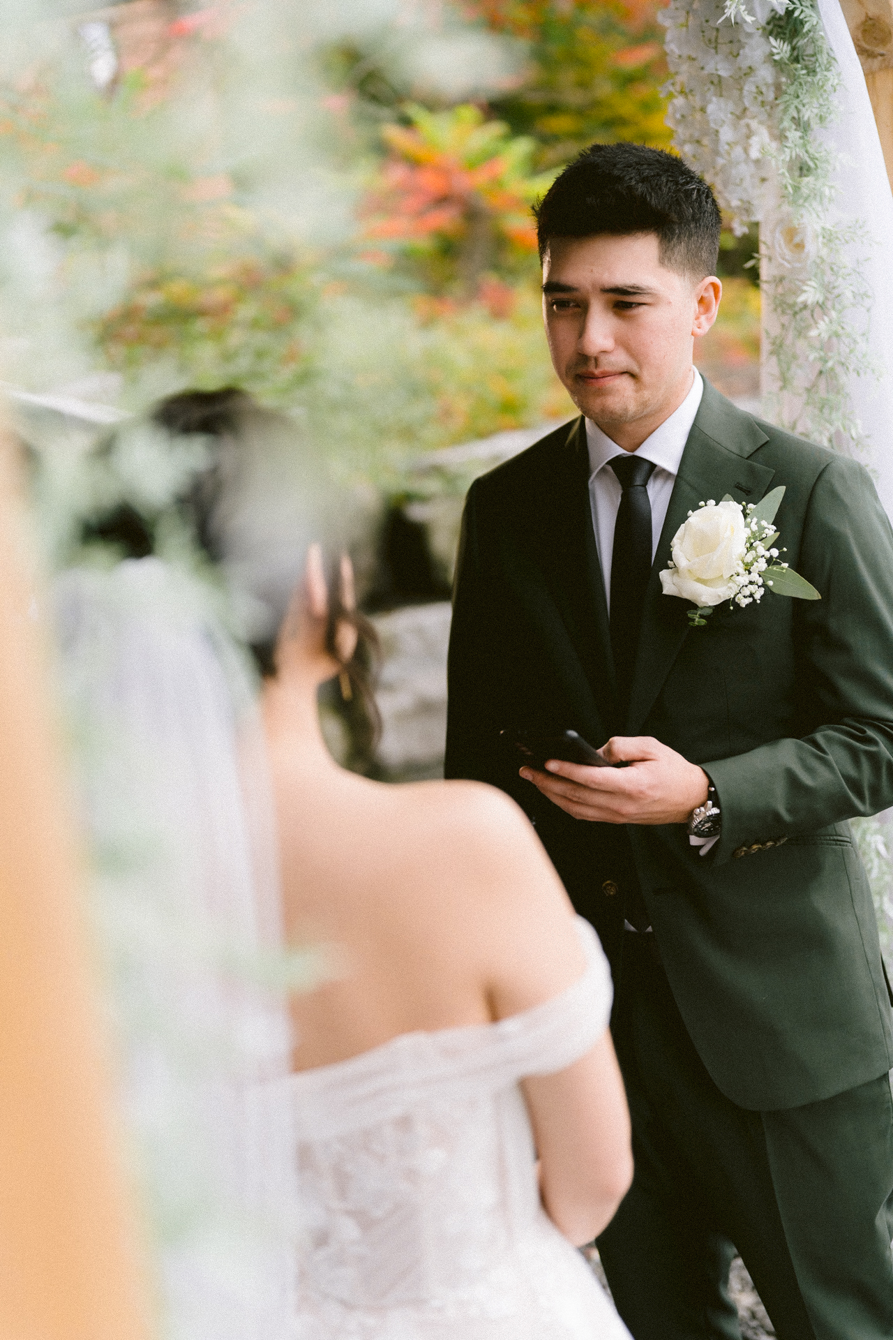A couple exchanges vows at an outdoor wedding ceremony
