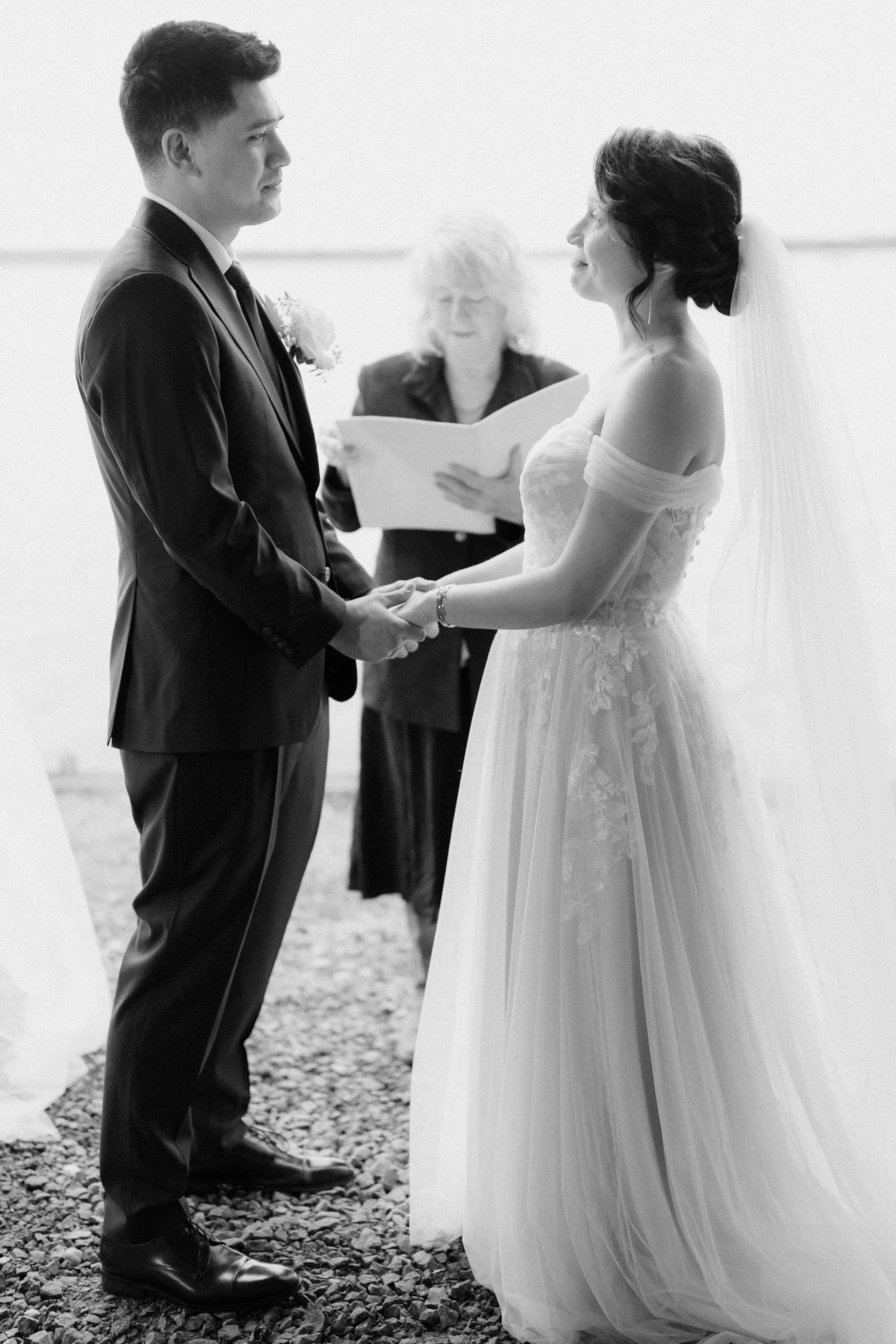 A couple exchanges vows at an outdoor wedding ceremony