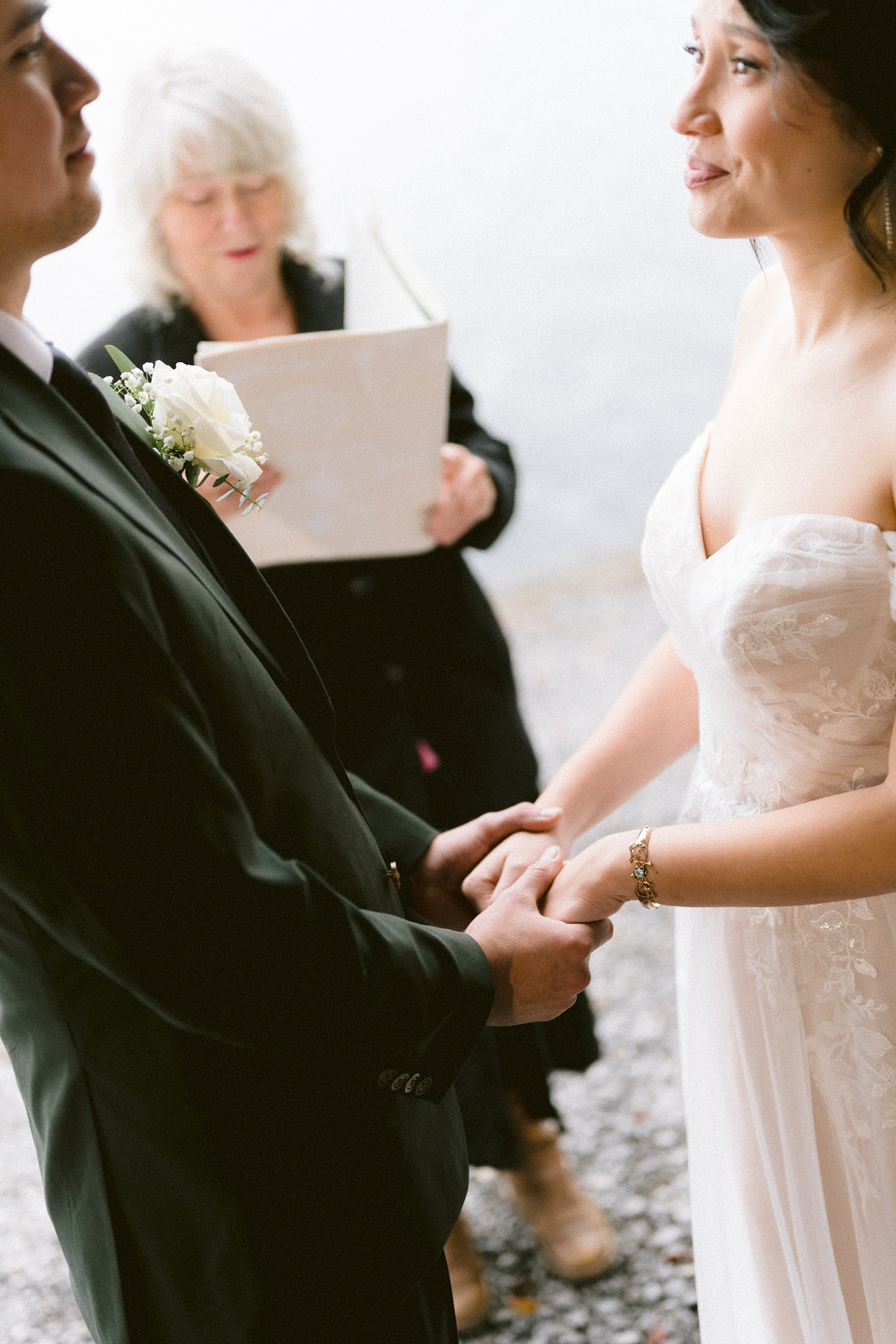 A couple exchanges vows at an outdoor wedding ceremony