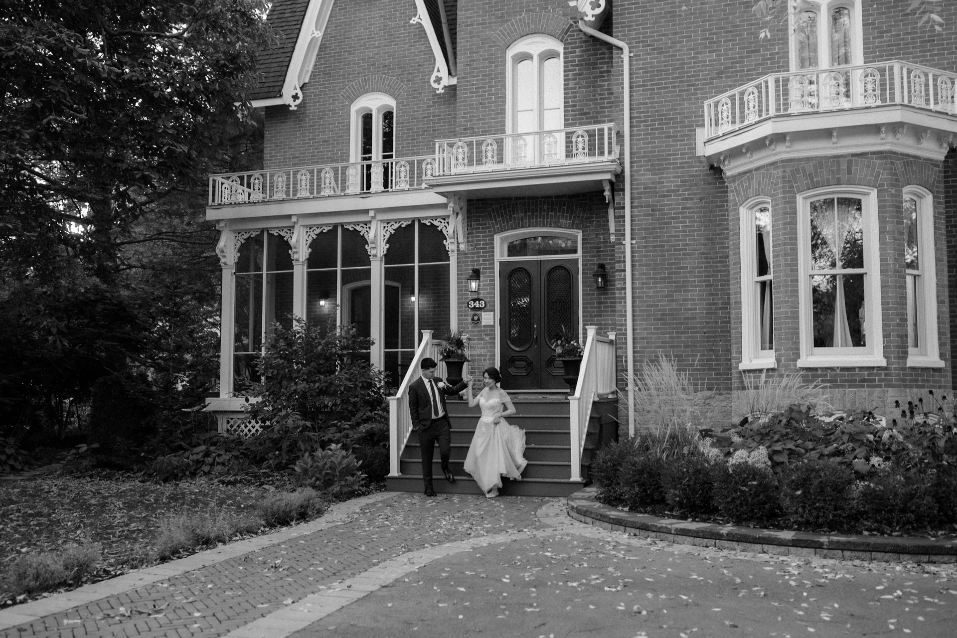 Bride and groom holding hands and posing for their couple portrait at Merrill House.