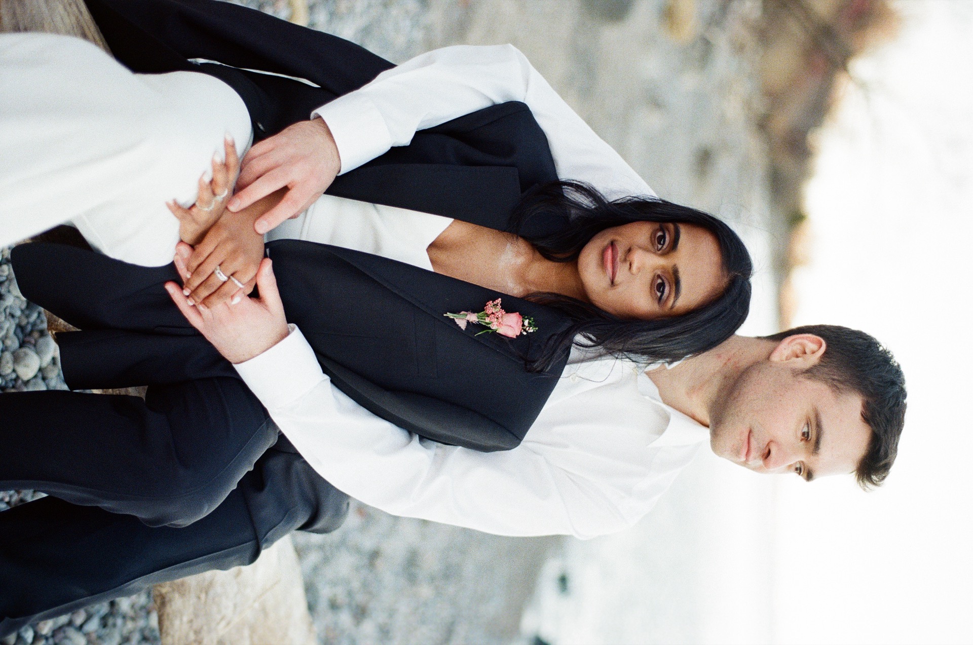 Groom hugs his bride from behind and enjoy the sunset together after their elopement.