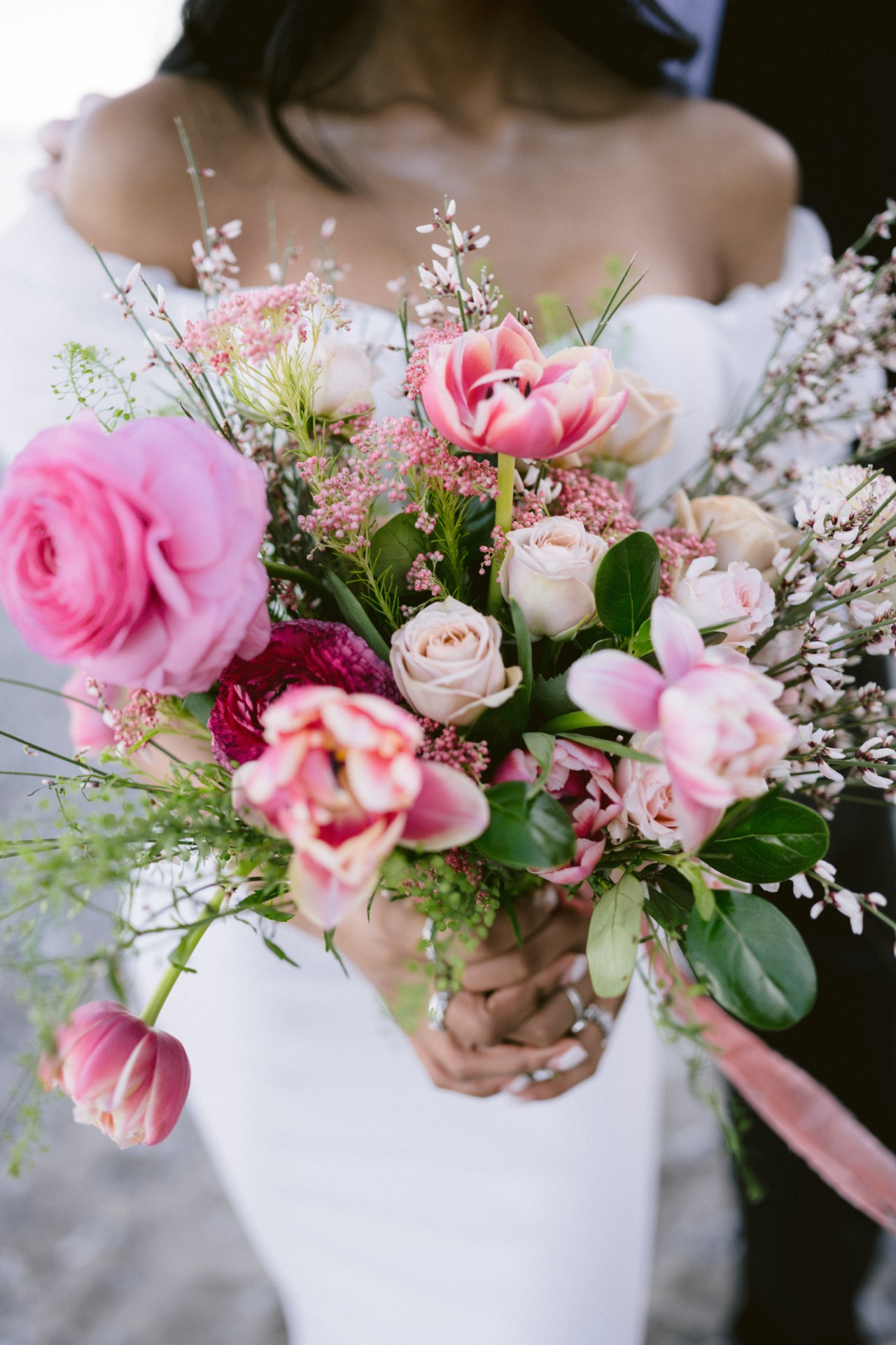 A pink and red roses been designed as a wedding bouquet.