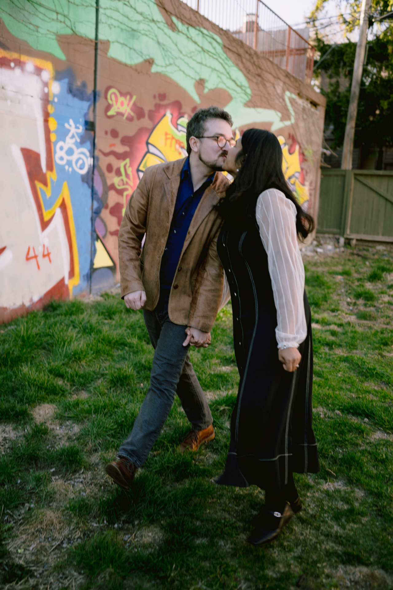 Couple share a kiss while enjoying their engagement photoshoot.
