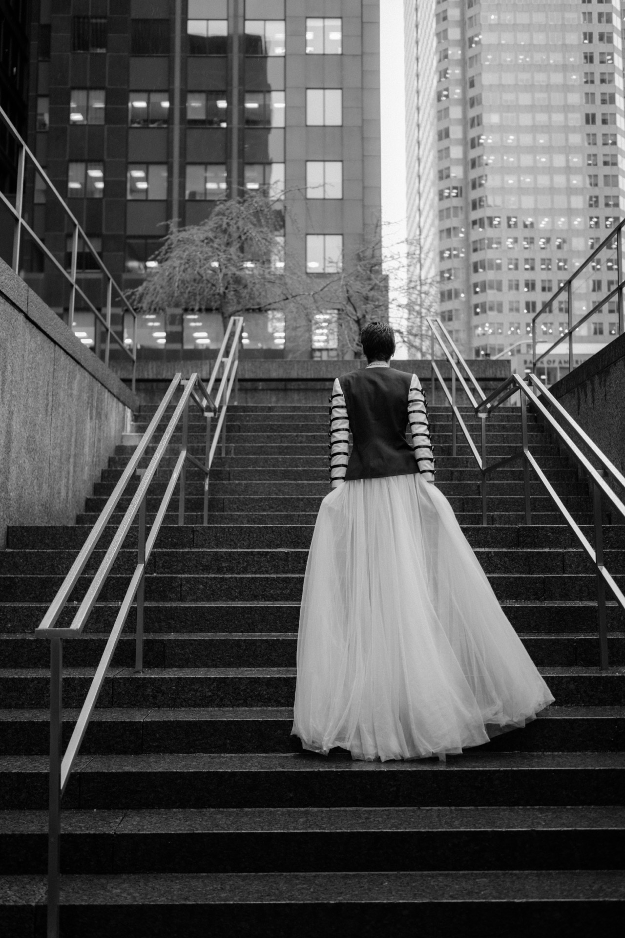 Gay couple walking in the rain for their wedding photos.