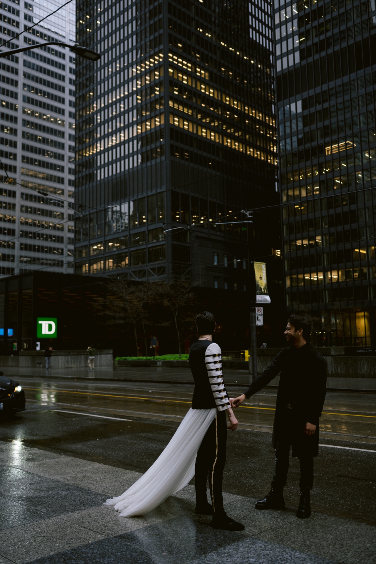 Gay couple walking hand in hand for their wedding photo.