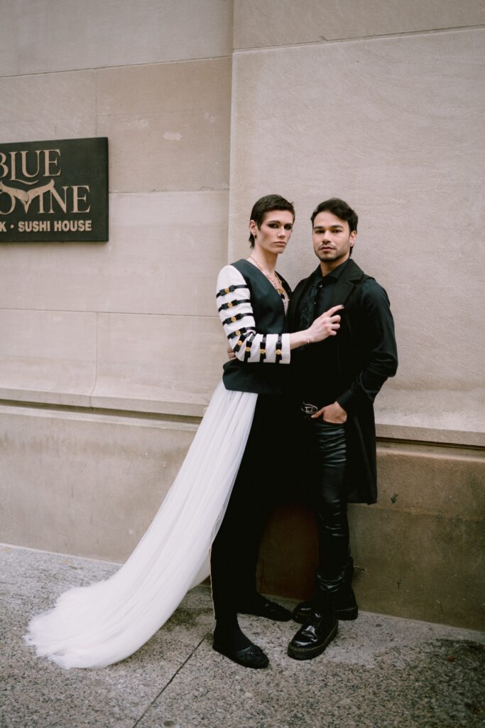 LGBTQ couple holding hands in the rain.