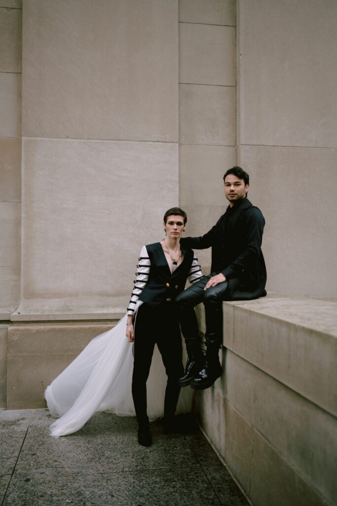 Gay couple sitting together at Union Station for their wedding photos.