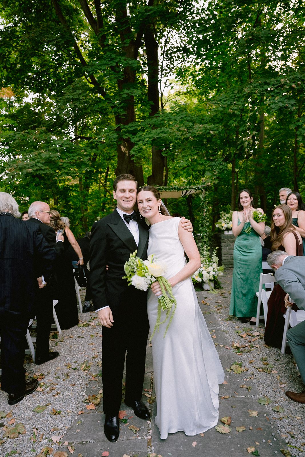Bride and groom exit the wedding ceremony at The Estates of Sunnybrook