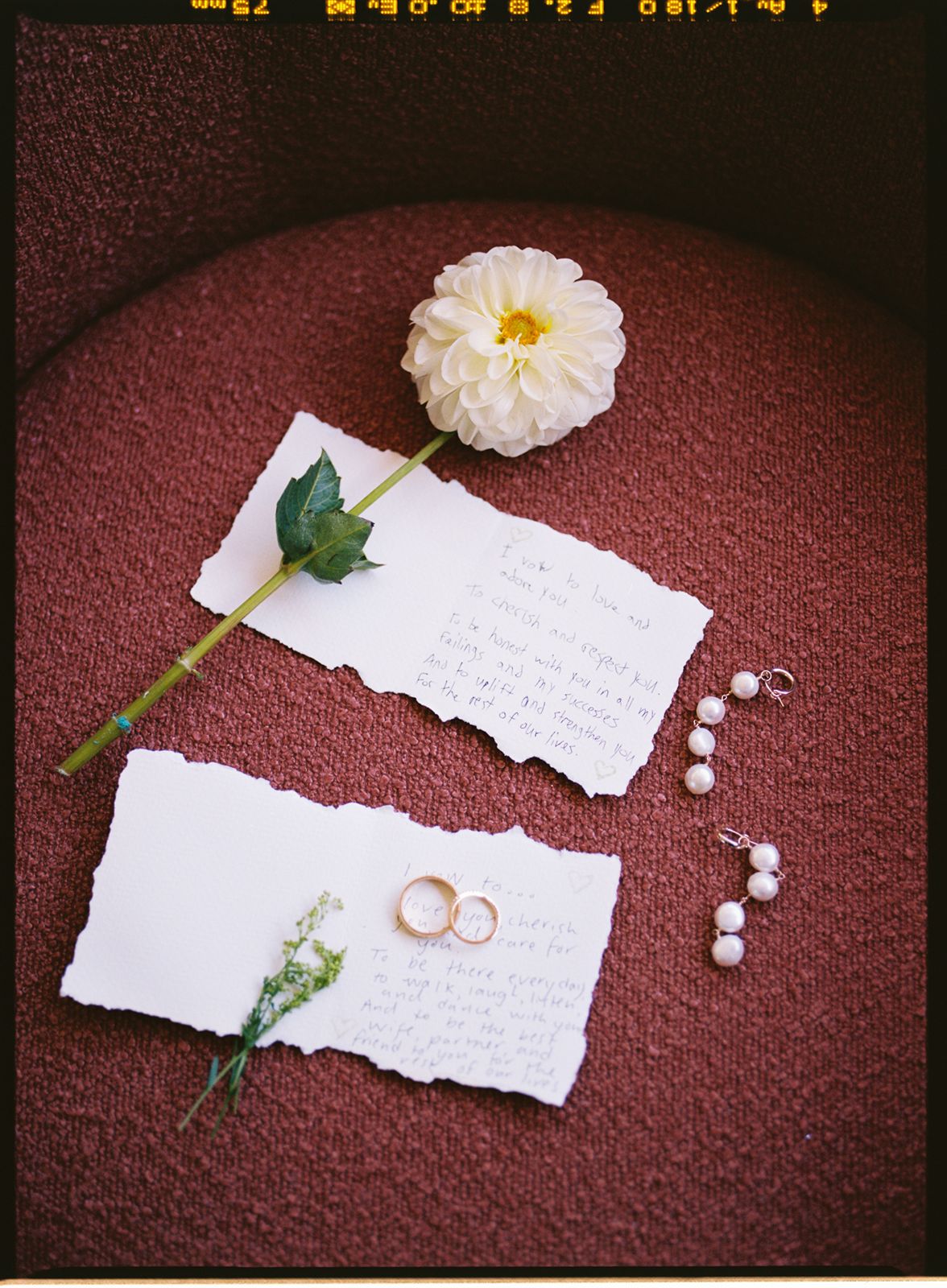 A love letter displayed with wedding rings and accessories