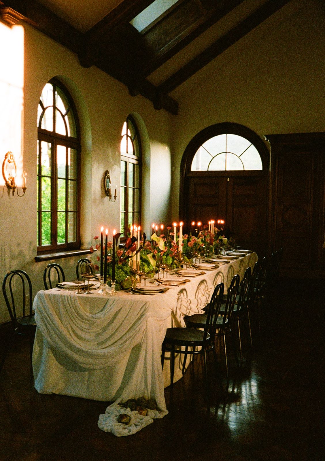 Candlelit wedding reception table with floral decoration