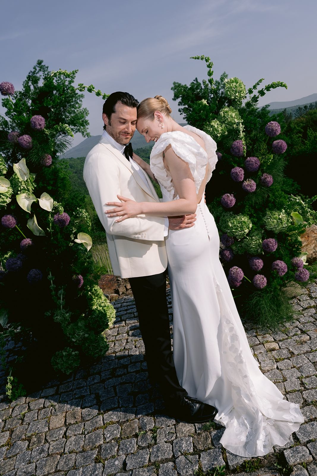Bride and groom kissing each other at their wedding ceremony