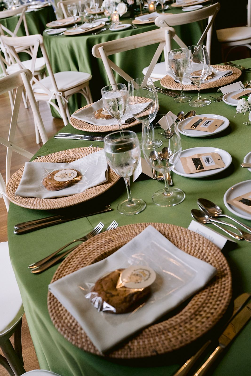 Close up of green wedding reception decor and stationary.