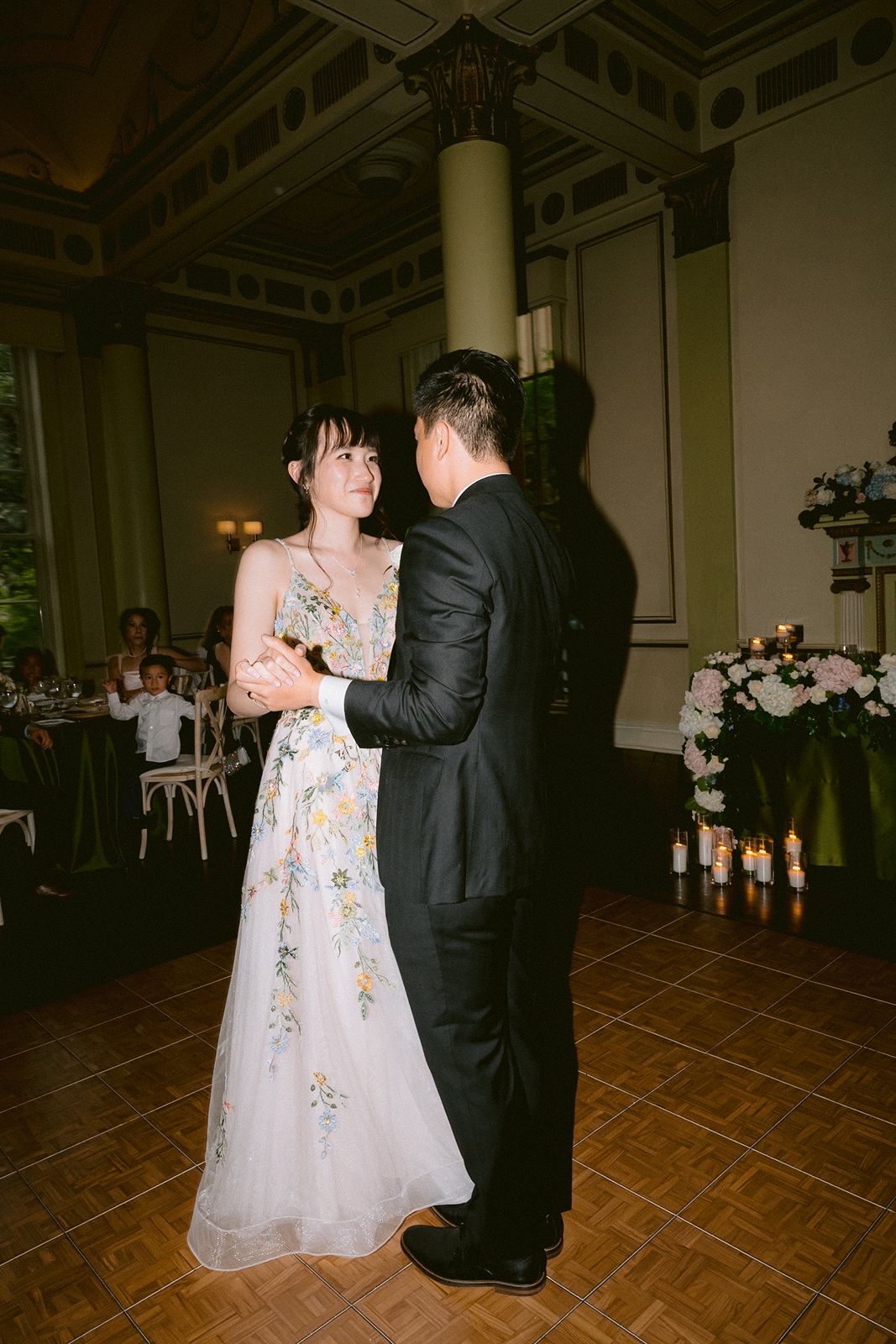 Bride in second wedding dress: a pink floral gown for the first dance.
