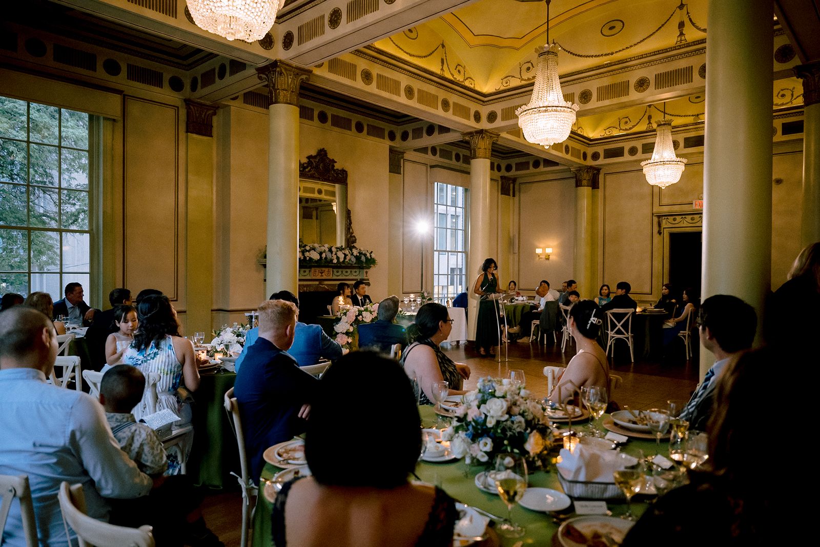 Lush greenery and floral designs for a historic indoor wedding.