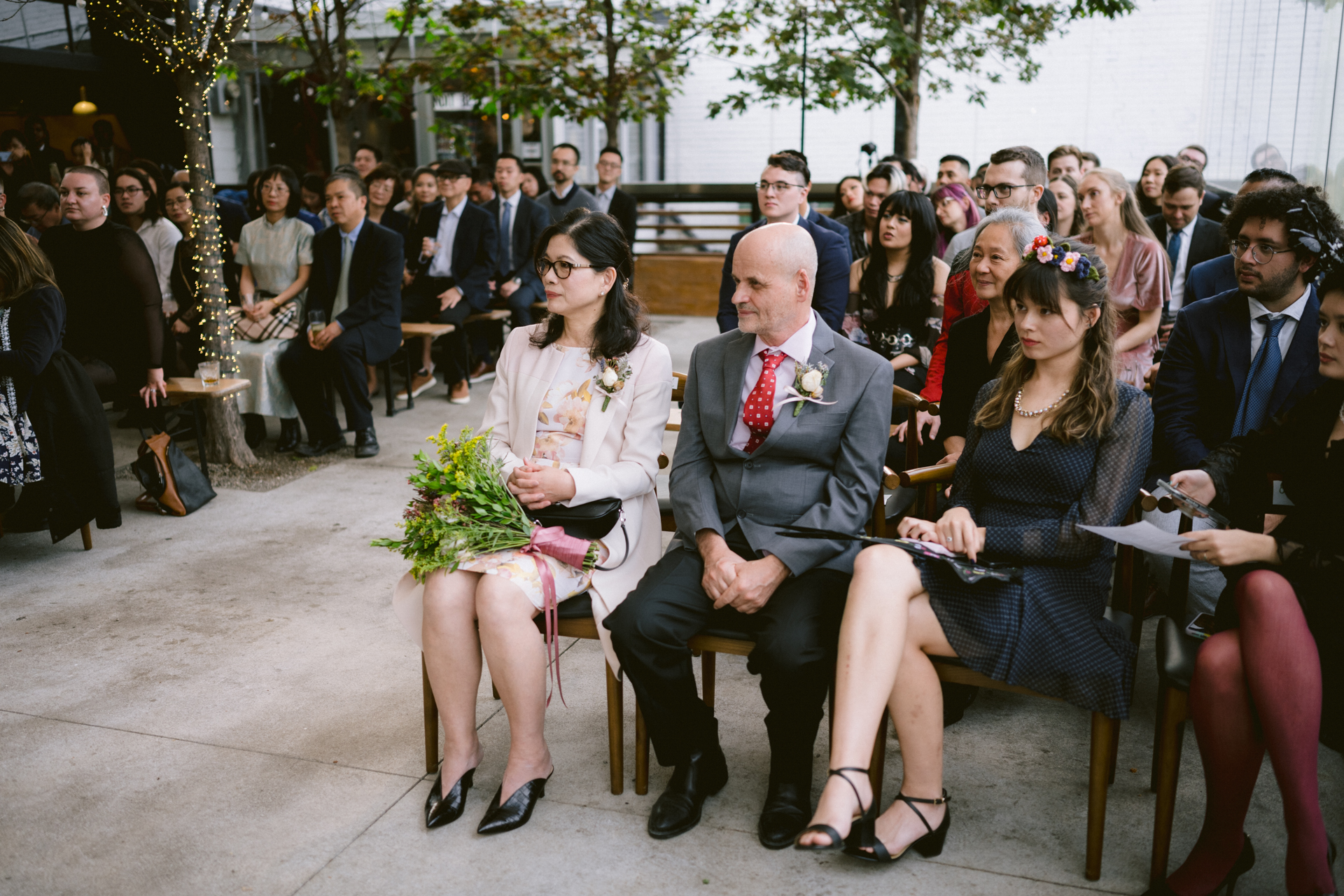 Guests seated at an outdoor micro-wedding ceremony