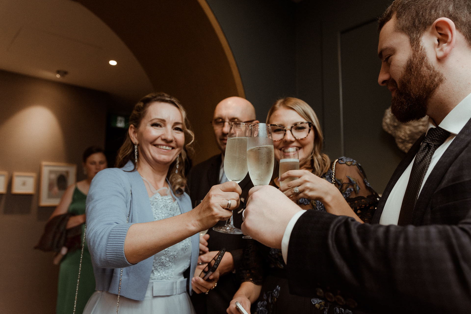 A group of people toasting with champagne glasses at a wedding