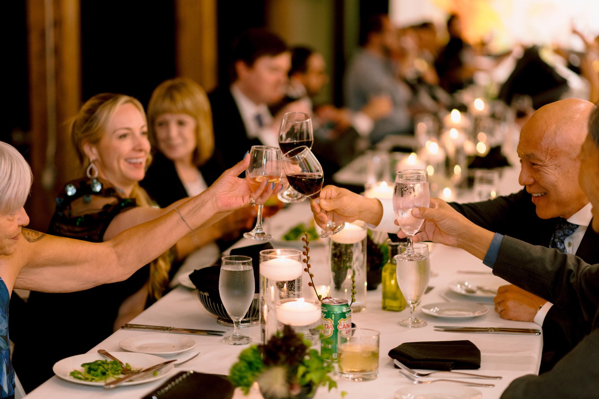 Guests toasting with wine glasses at a wedding
