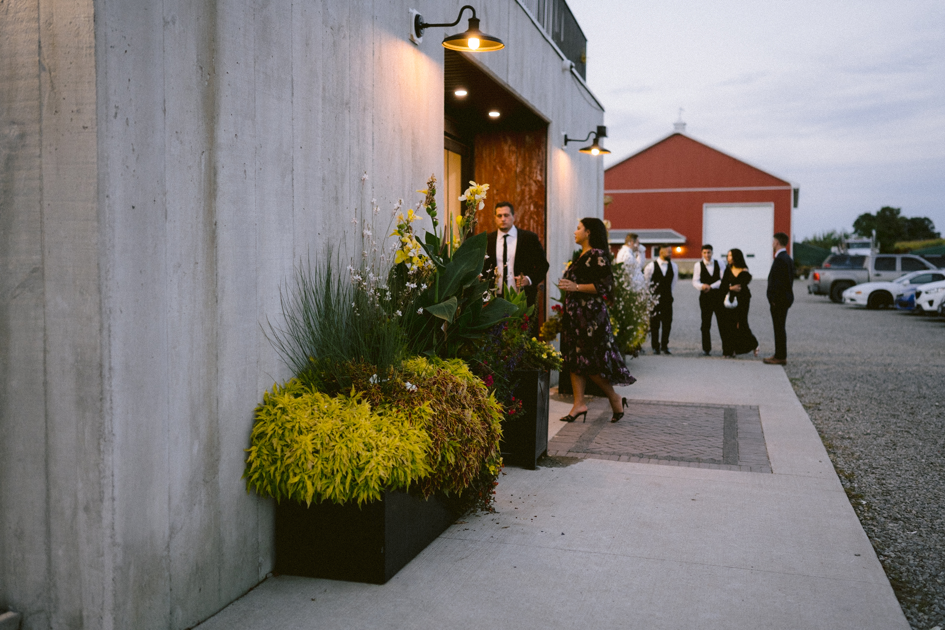 Guests mingle around at the spacious outdoor of The Byre at Cambium Farms.