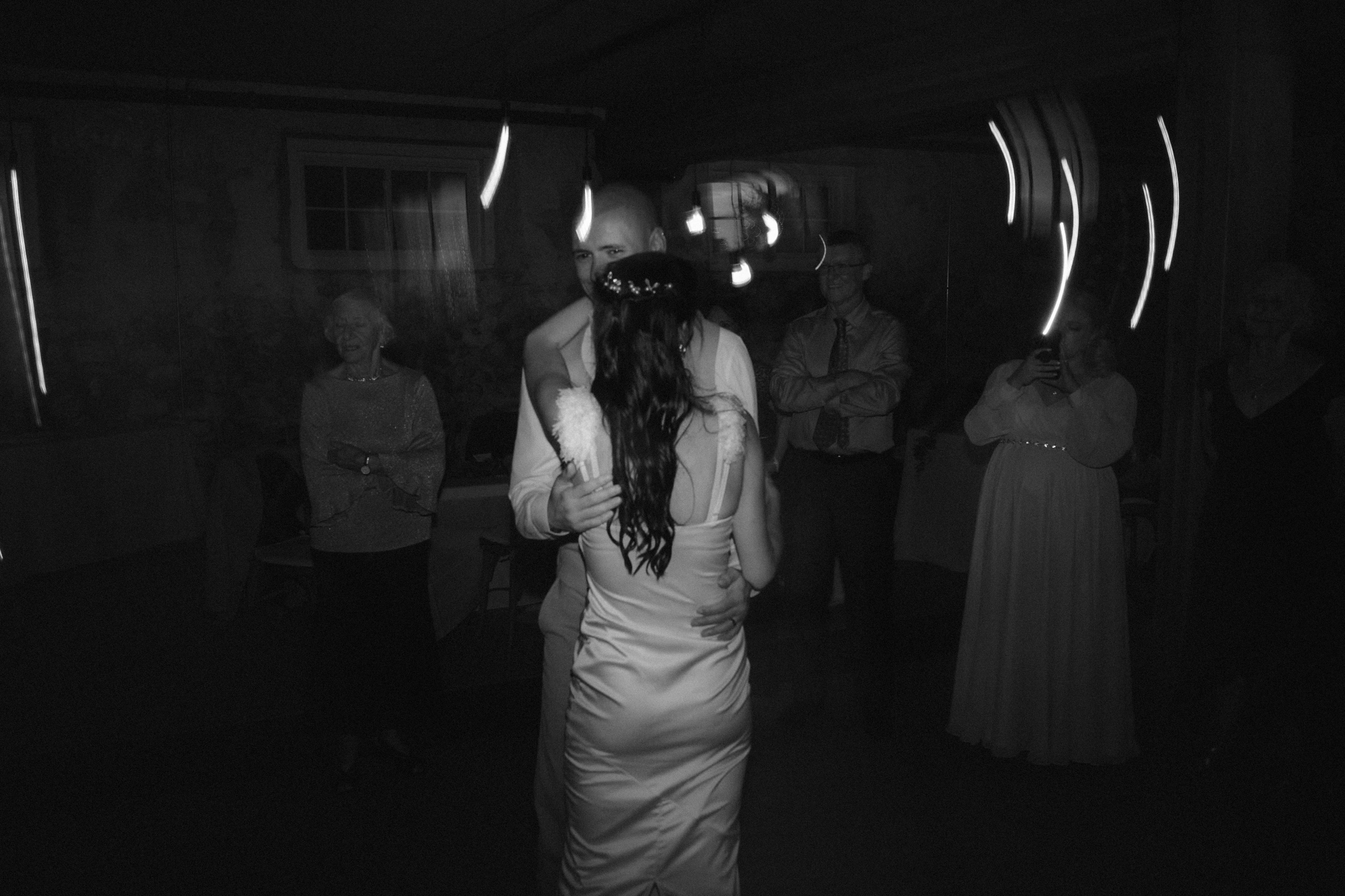 Bride and groom share a final dance, marking the end of their wedding day.