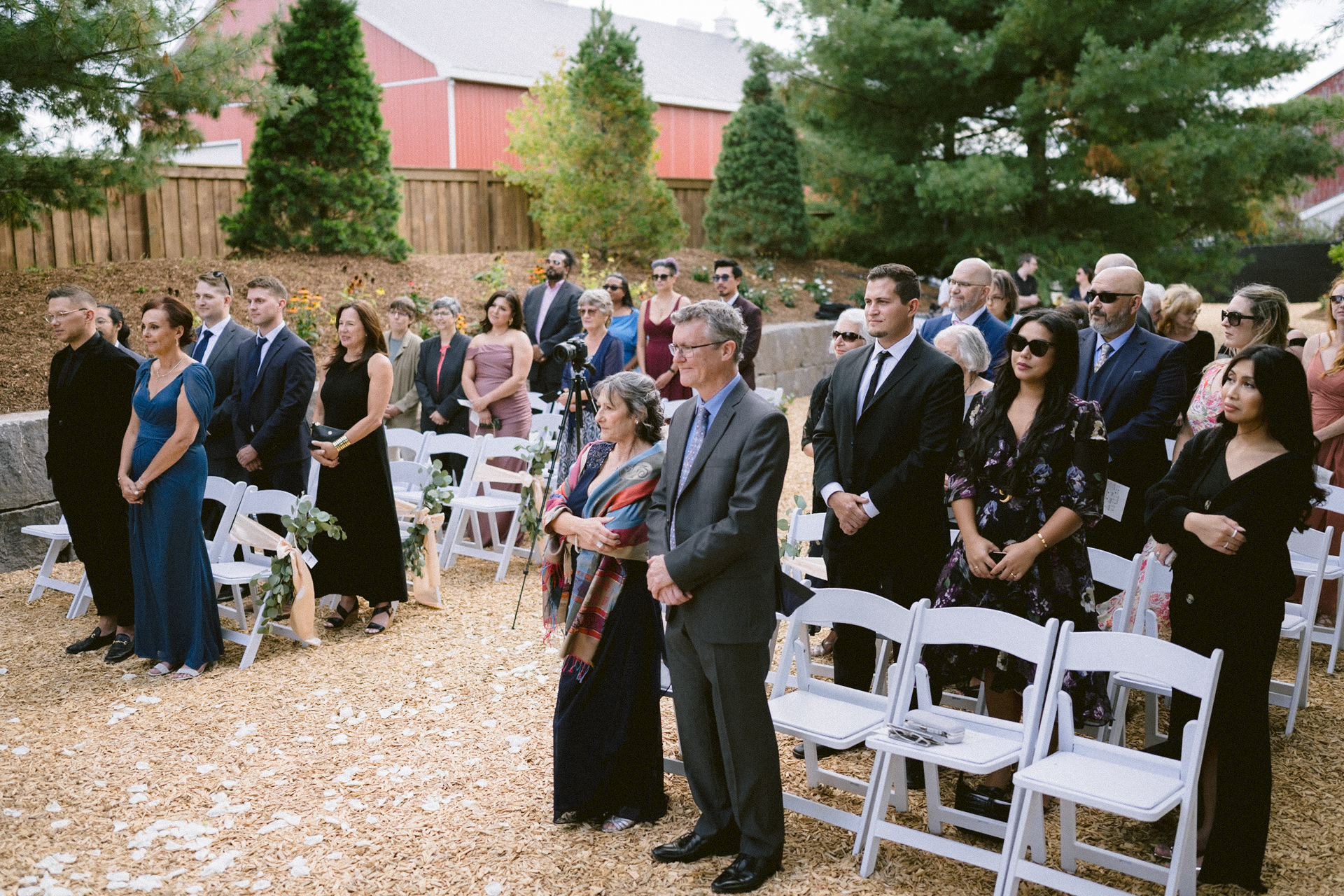 Guests standing at an outdoor wedding ceremony at Cambium Farms