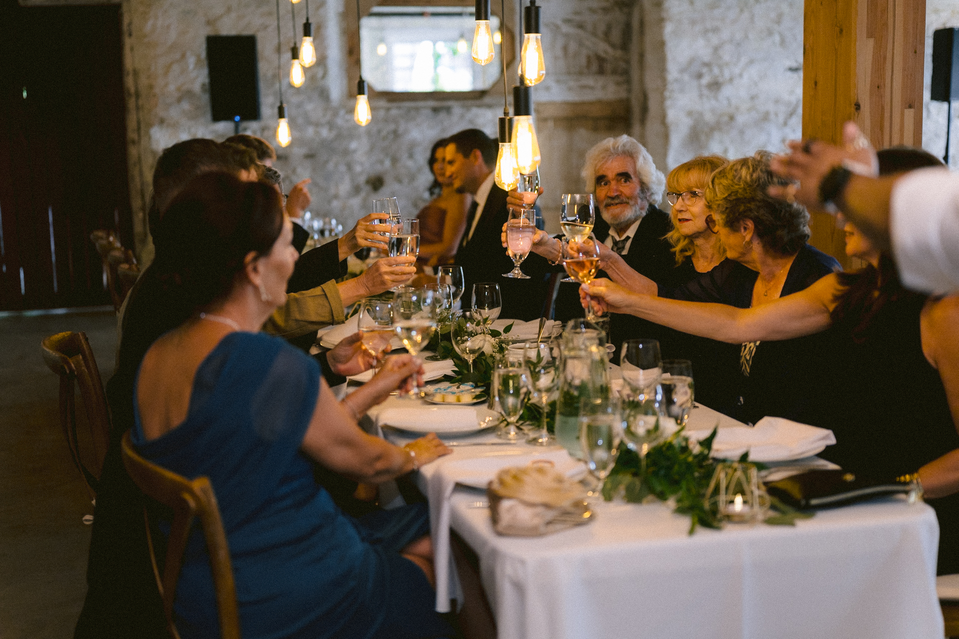 Guests toasting at a wedding reception at Cambium Farms.
