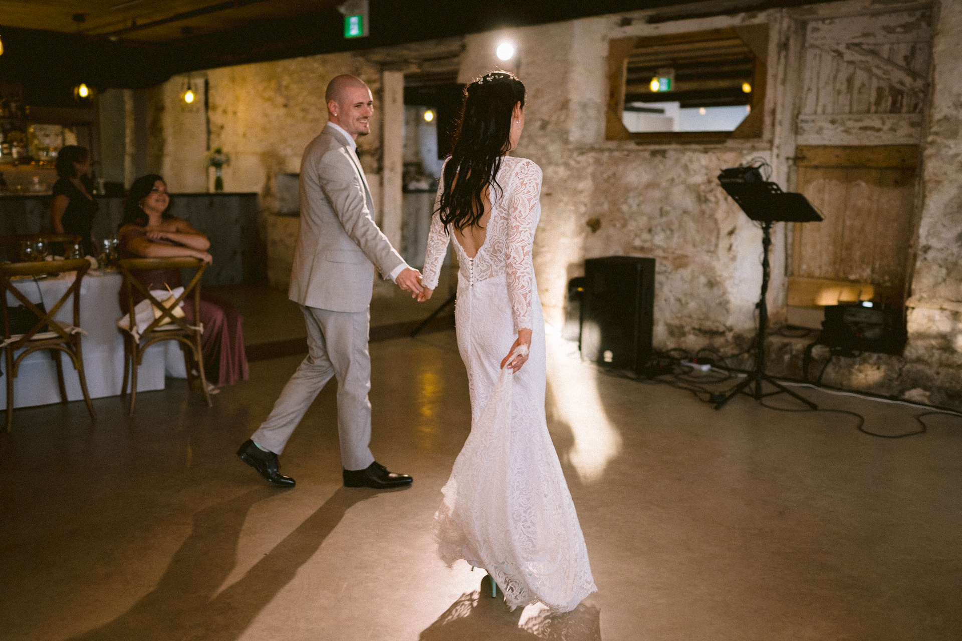 Groom holding his bride hand and invite her to perform the first dance at a wedding