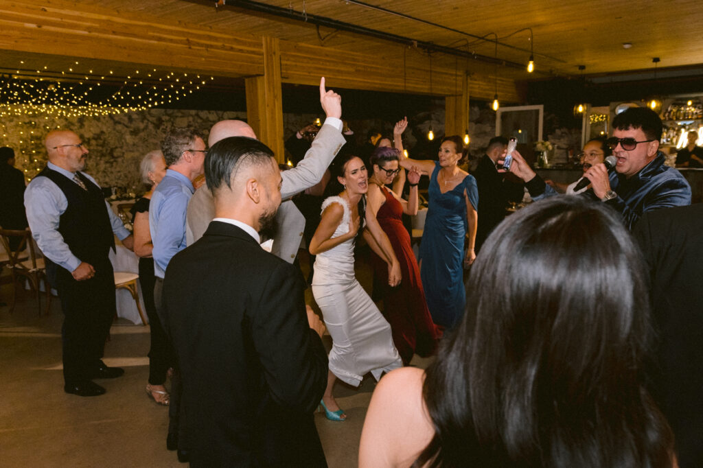 Bride sang with the singer and guests dance along with them at Cambium Farms wedding.
