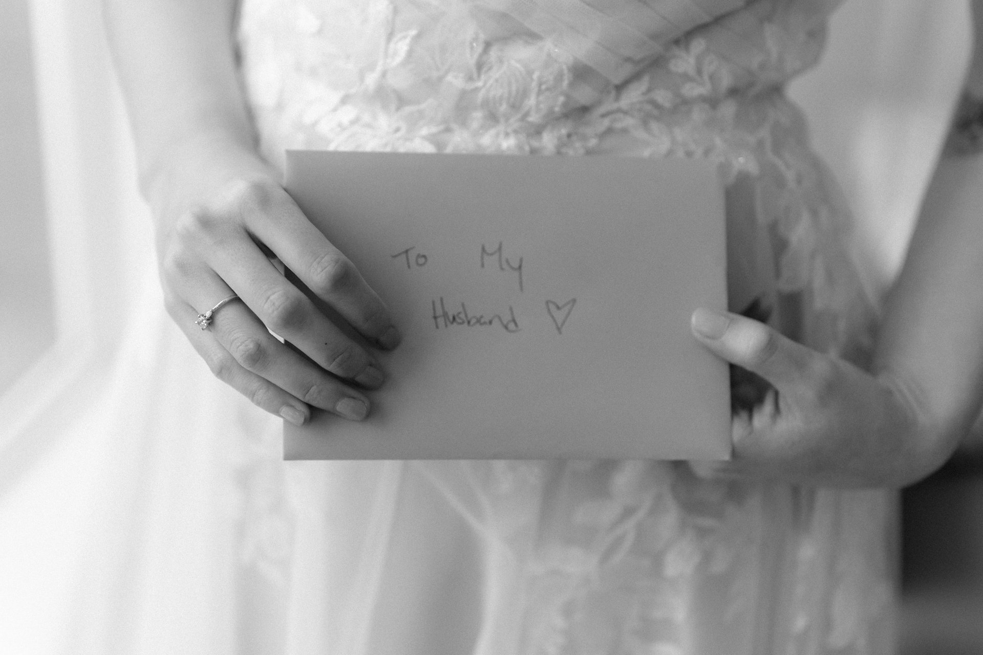 A bride holding a letter addressed 