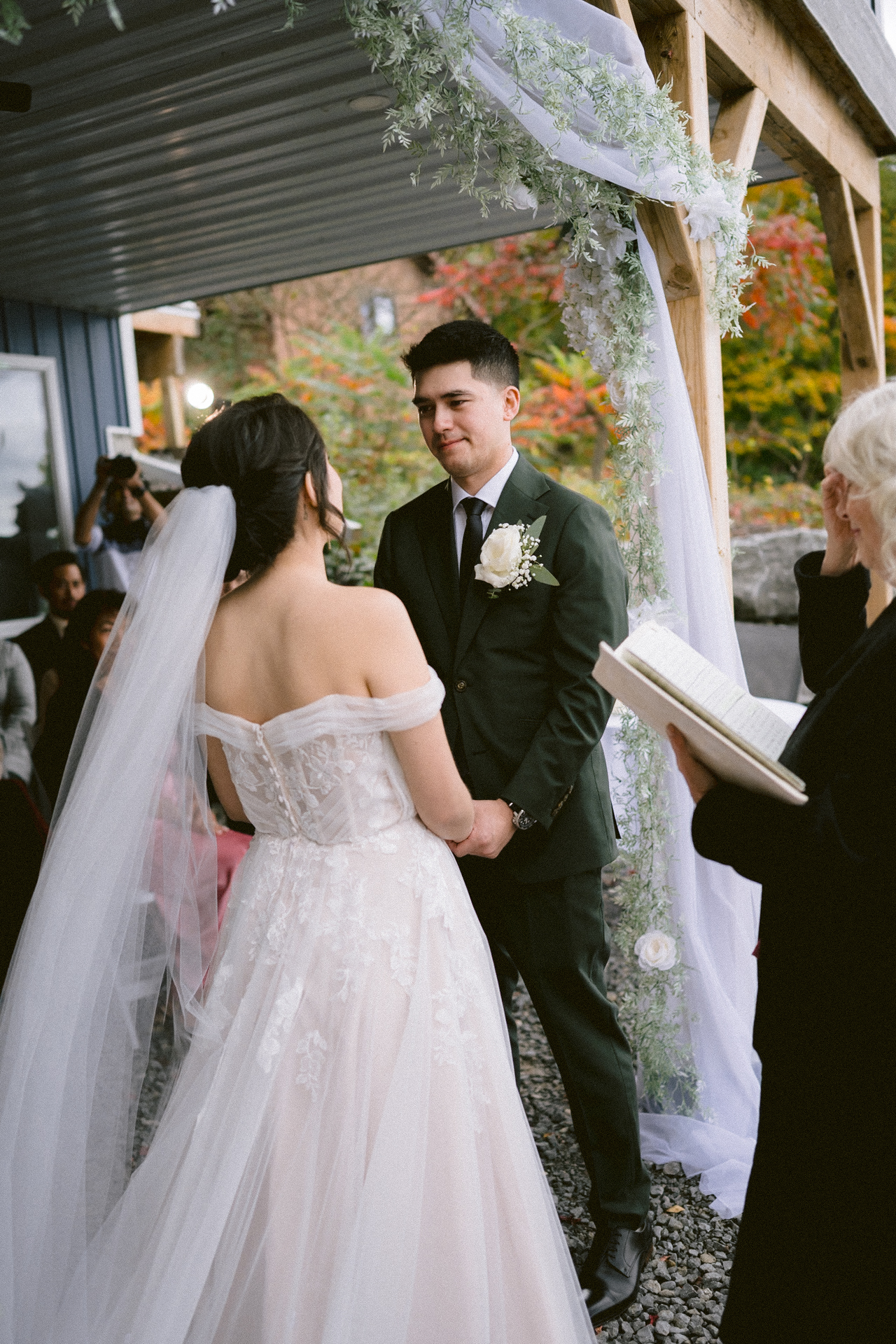 A couple exchanges vows at an outdoor wedding ceremony