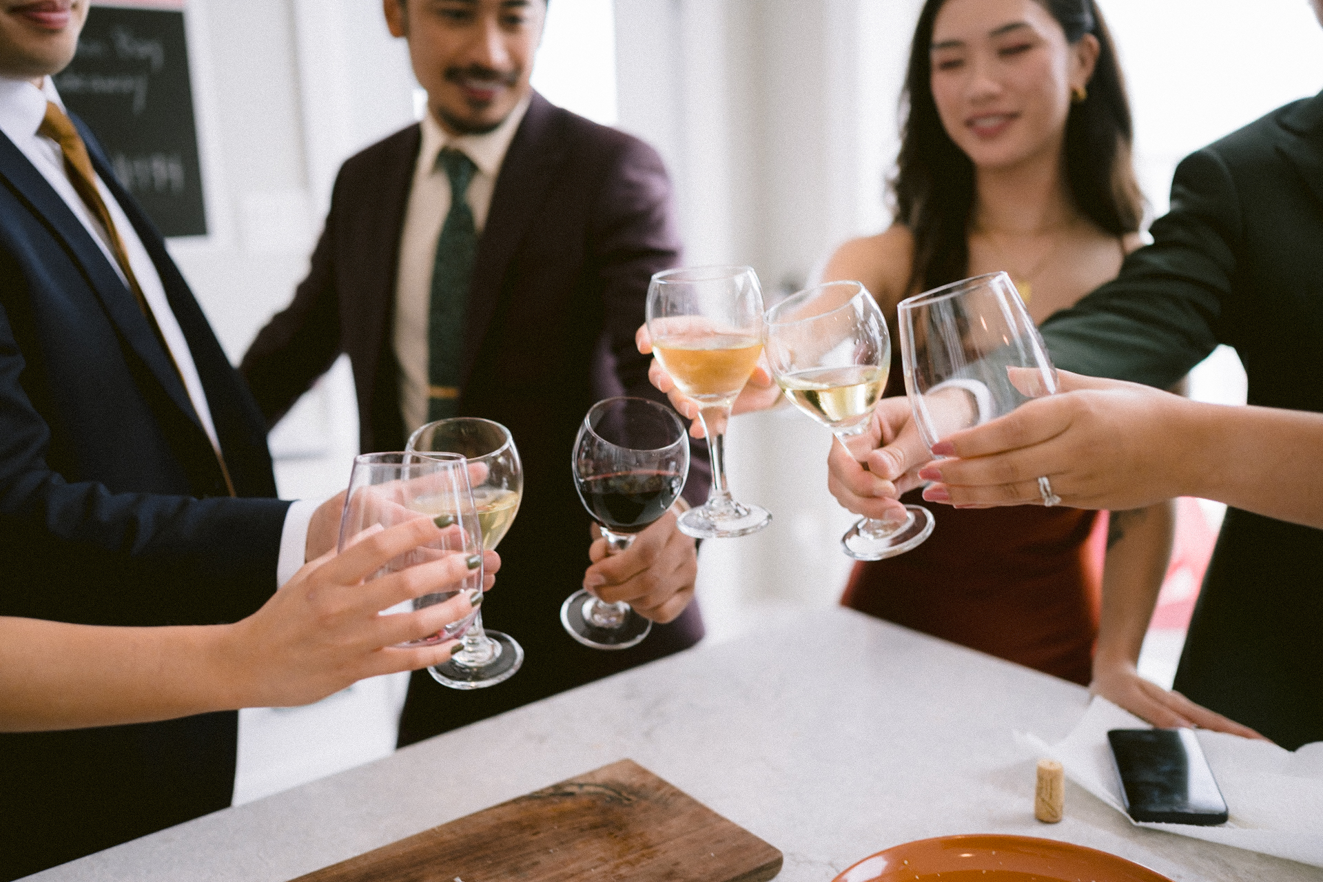 Group of people toasting with wine glasses.