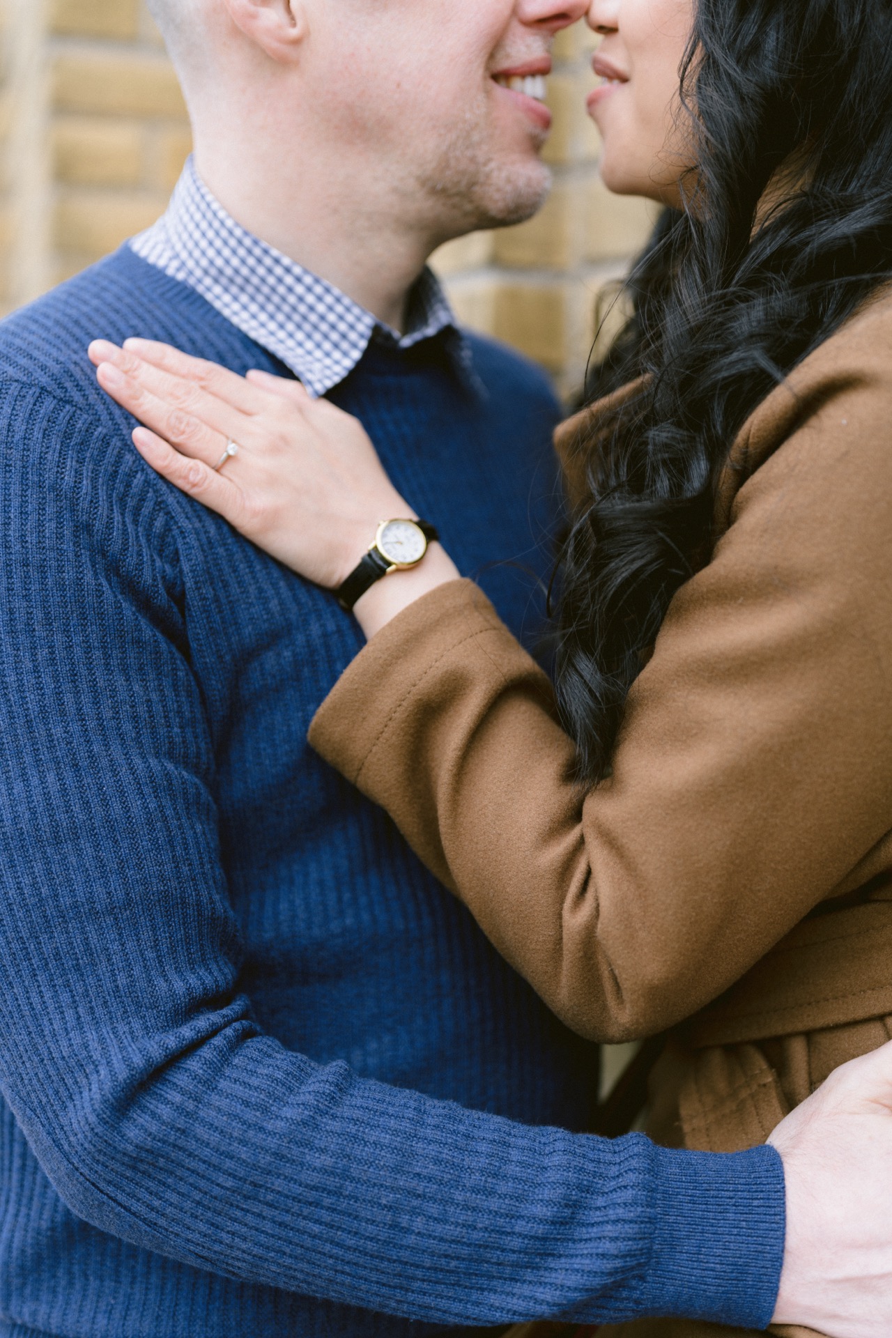 Close-up of a smiling couple embracing, focusing on their affectionate gesture.