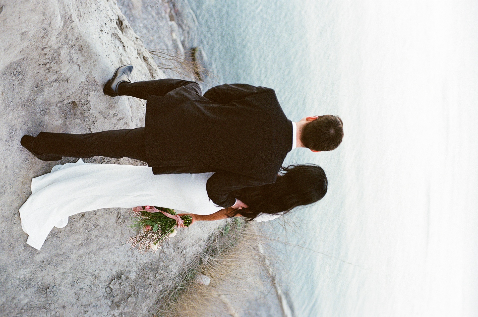 Couple stand at the top of hill for their wedding portrait after their wedding at Scarborough, Ontario