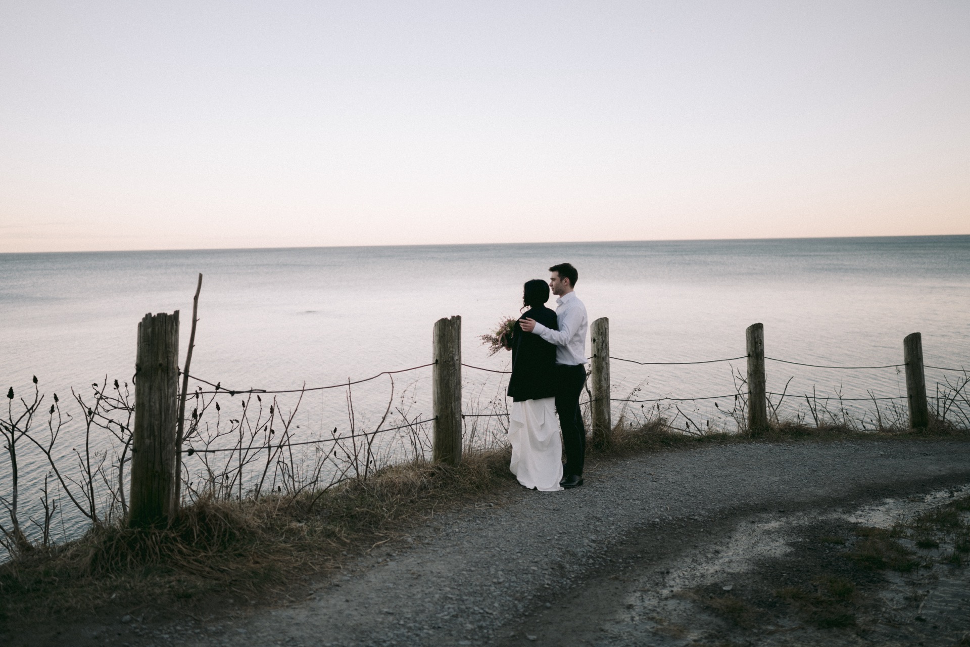 Couple enjoy the sunset view at Scarborough, Ontario after their wedding ceremony