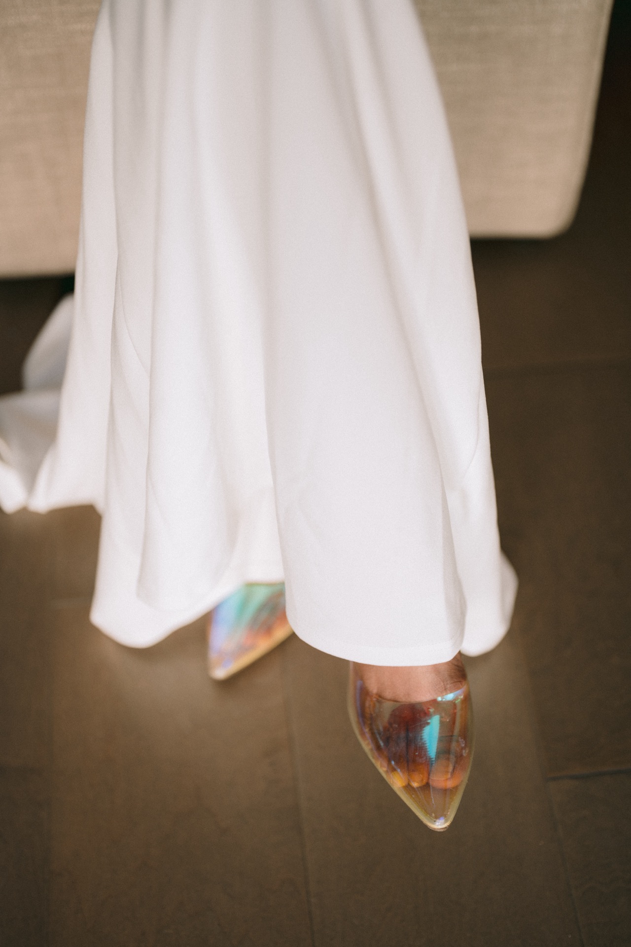 A close-up of a bride with her wedding shoe.