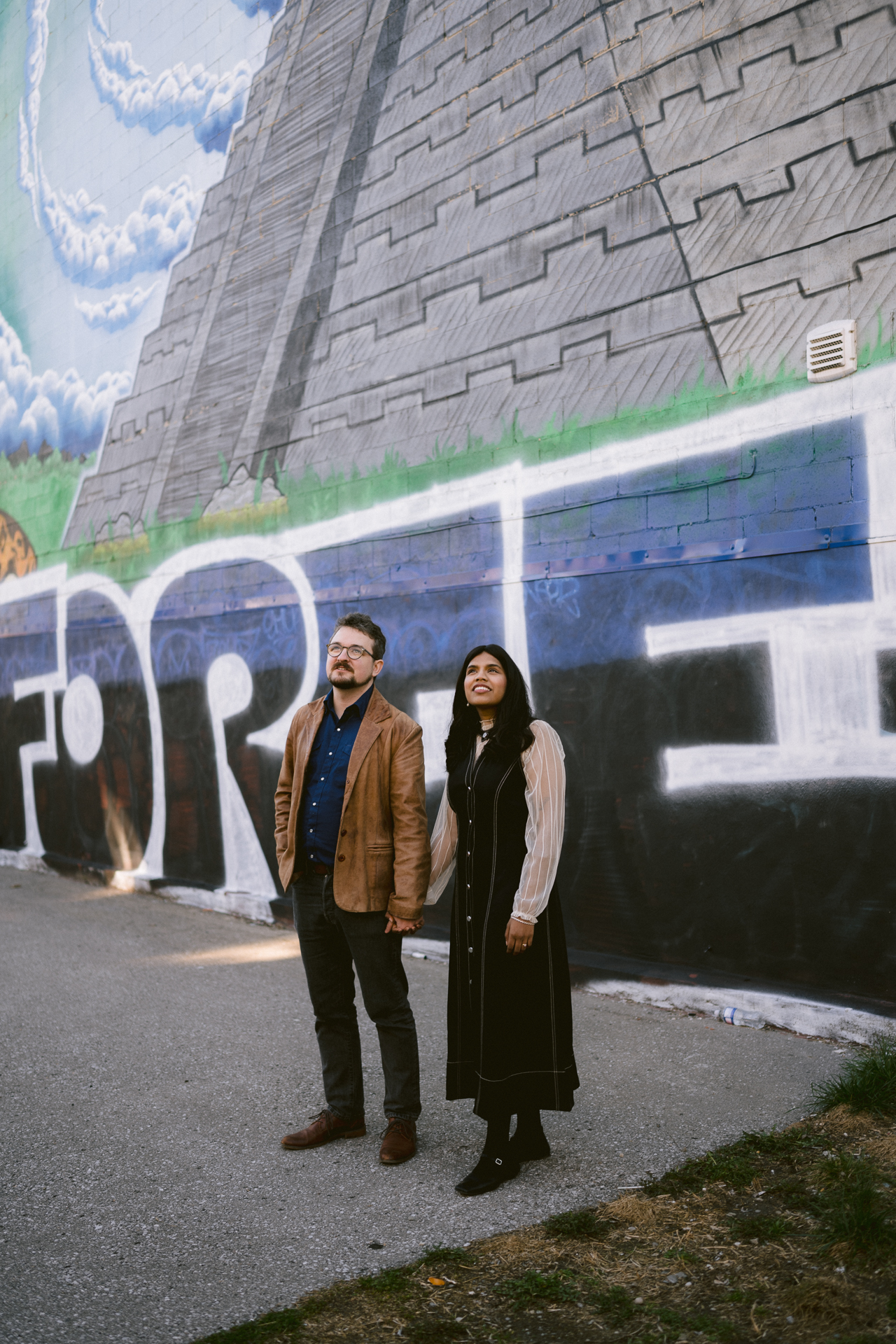 Couple holding hand and enjoy the artistic murals in Gerrard Street.