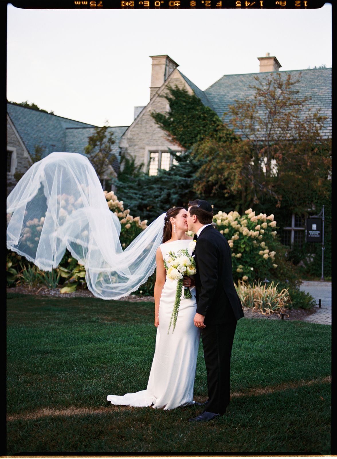 Bride and groom portrait with veil flying at The Estates of Sunnybrook