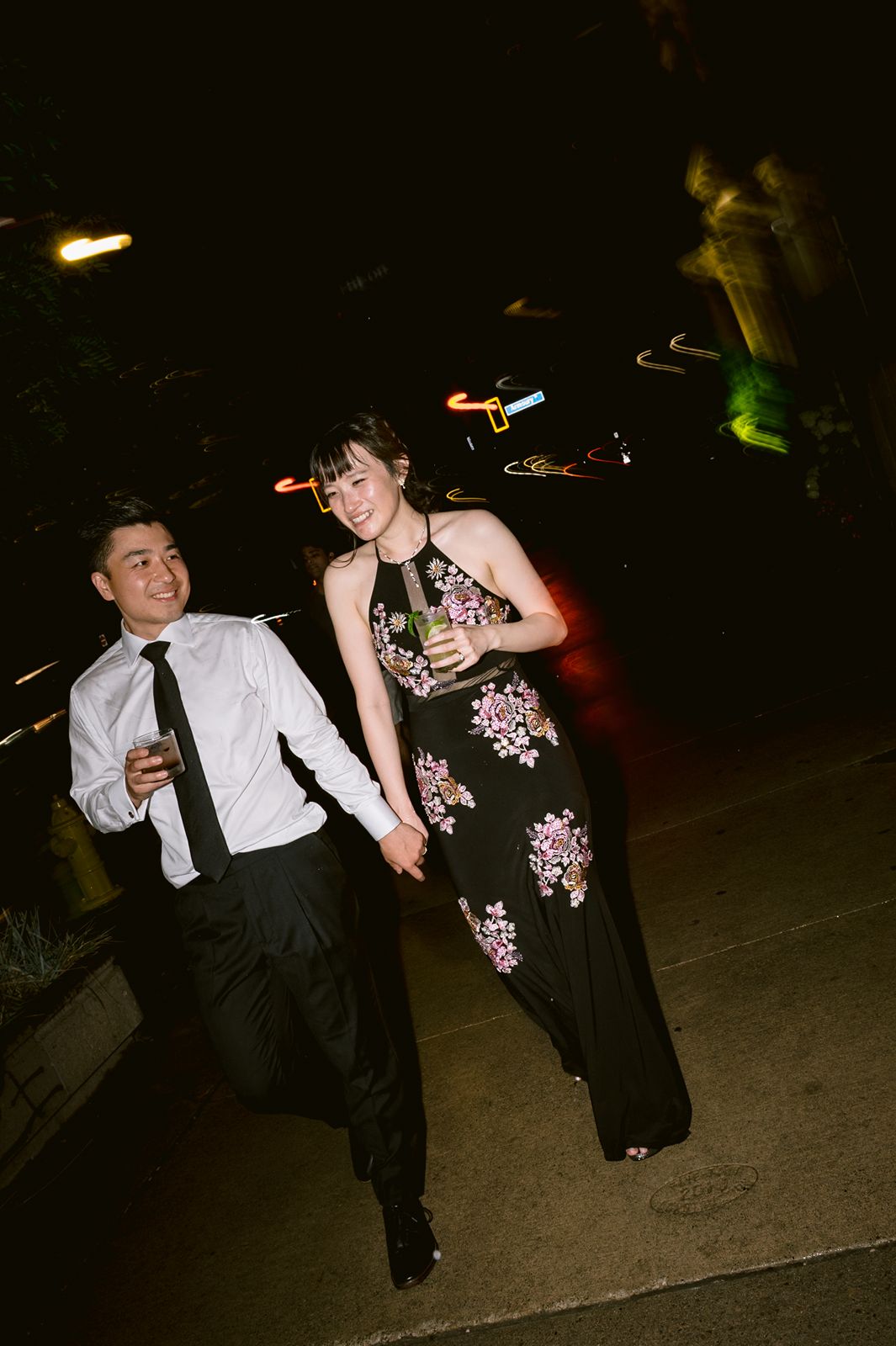 Groom holding the bride hands for a night walk.
