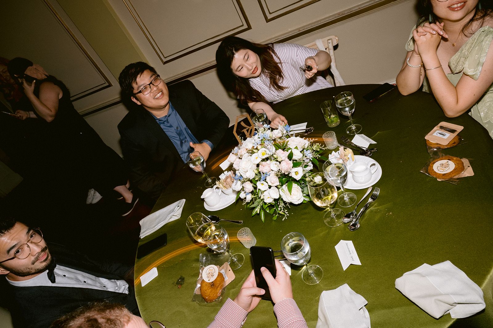 Intimate wedding dinner photography with candlelit glow.