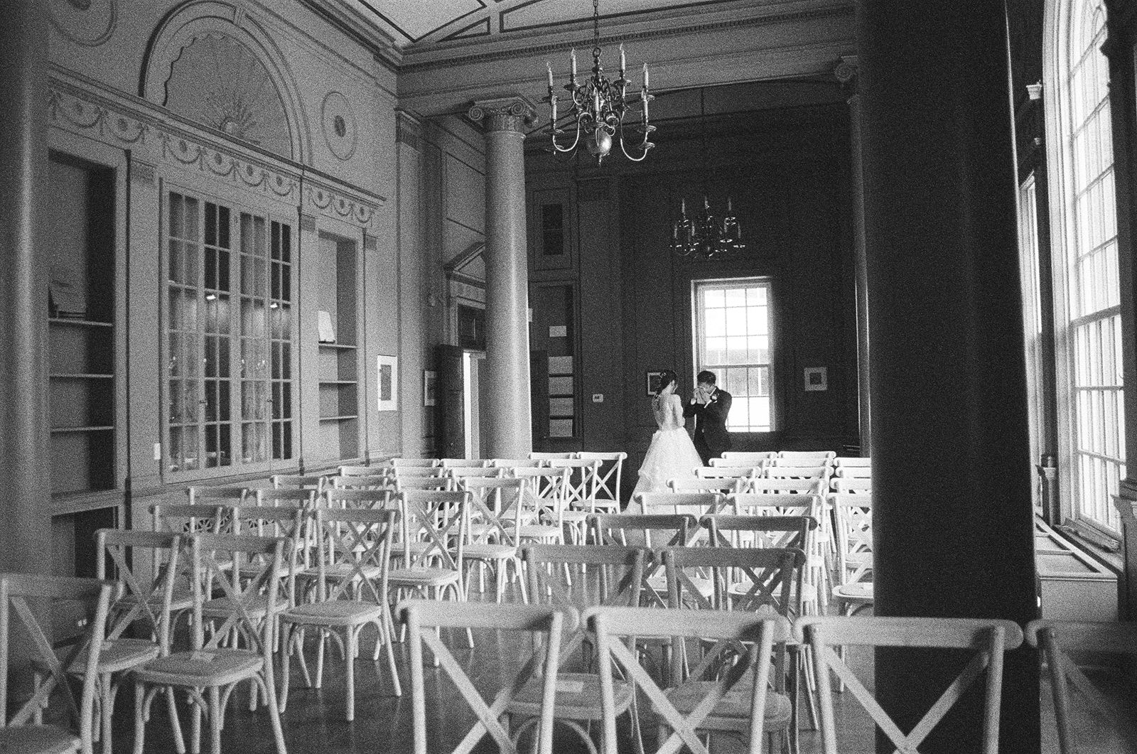 Bride and groom exchanging private vows in an empty Toronto wedding venue.