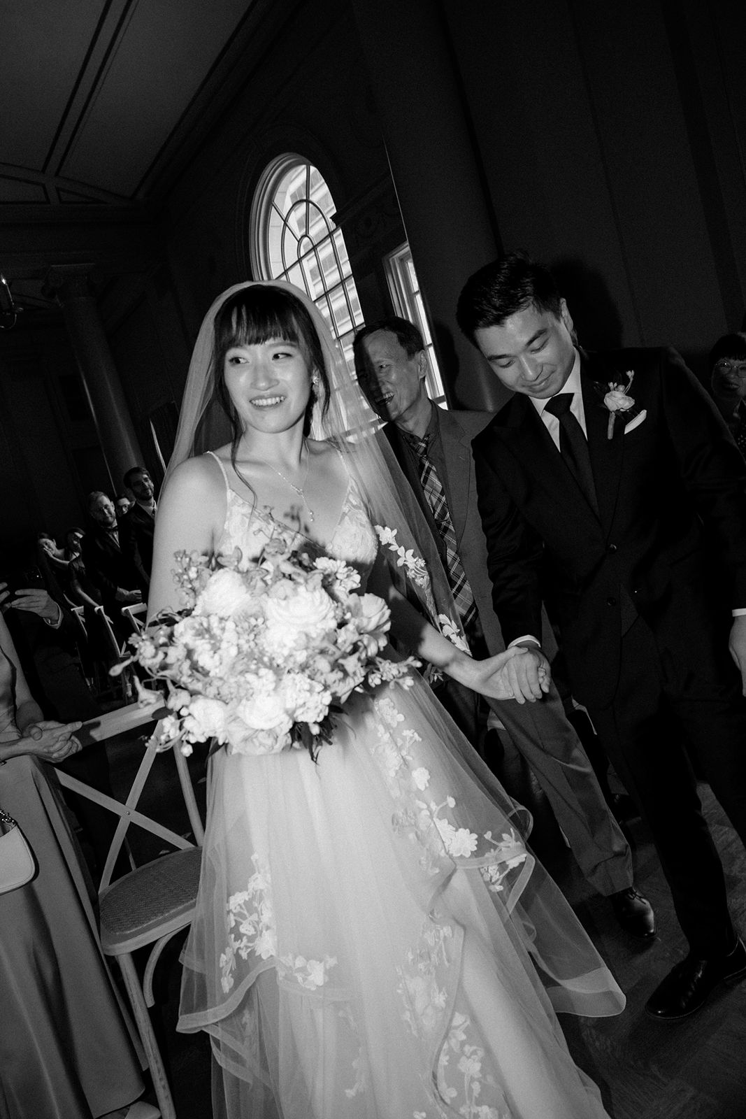 Bride and groom holding hands during vows.