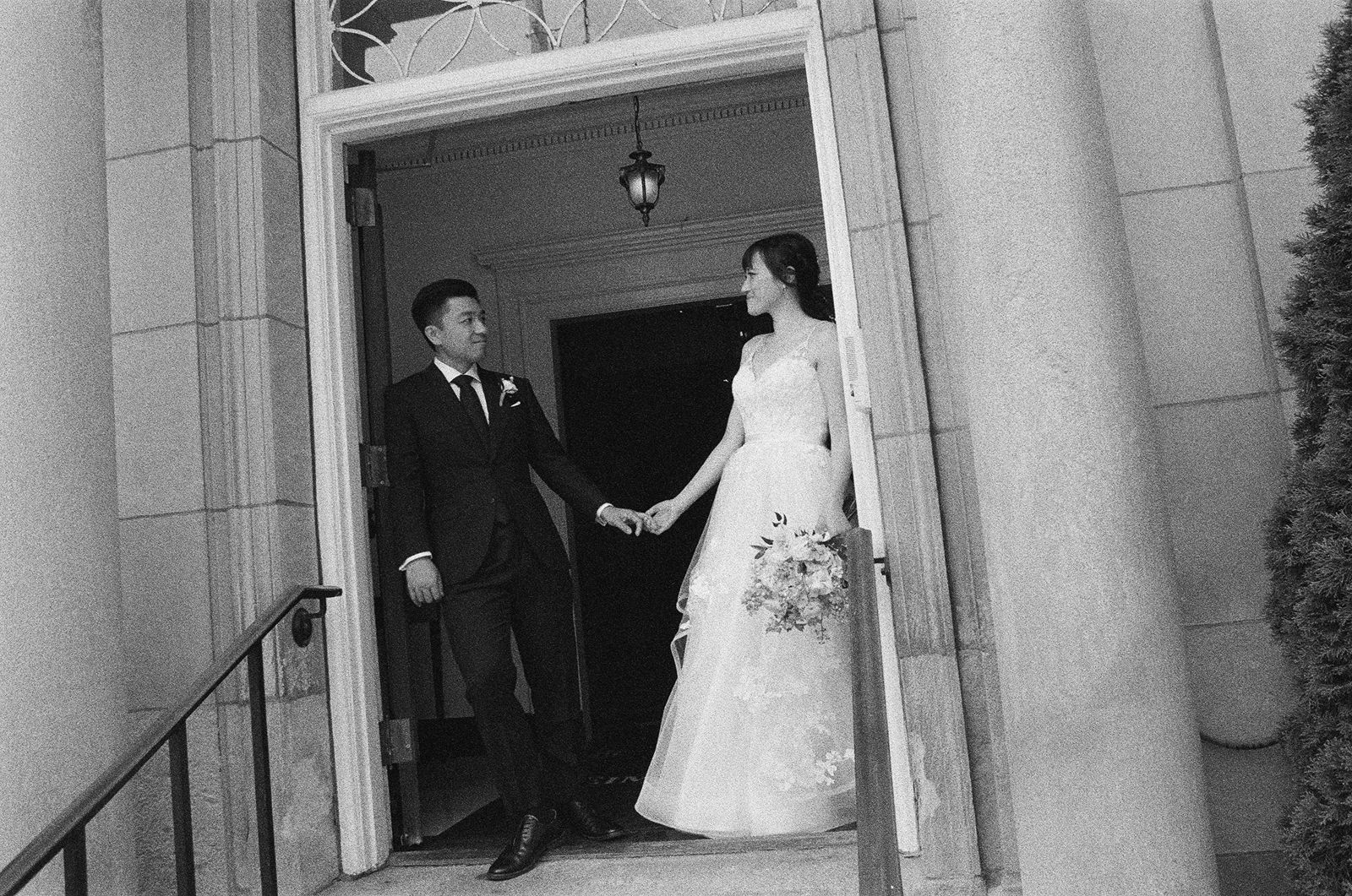Candid moment of a wedding couple looking into each other's eyes.
